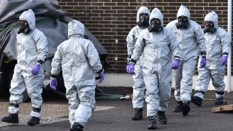 People in hazmat suits clean up the site of the poisoning of Sergei Skripal in Salisbury