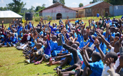 Happy_African_Students_Sitting_and_Raising_Hands