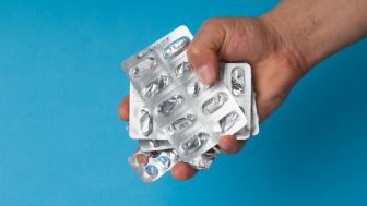 Hand holding empty pill blisters